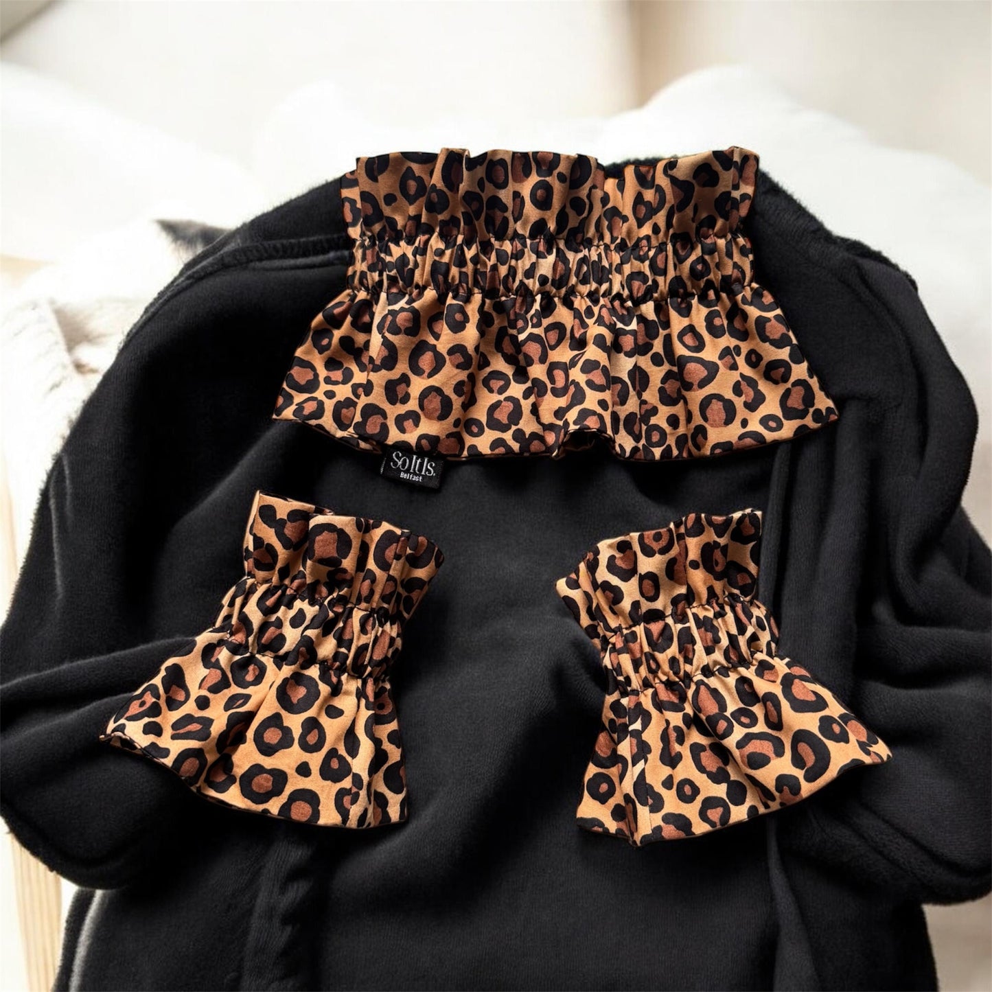 Leopard print detachable collar and matching cuffs displayed on black sweater by So It Is Belfast