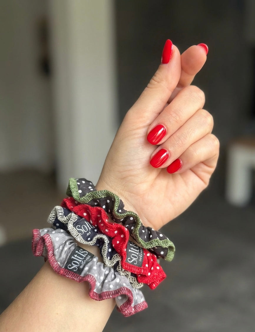 Woman wearing polka dot frill edge scrunchies on wrist, handmade hair accessories set by So it is