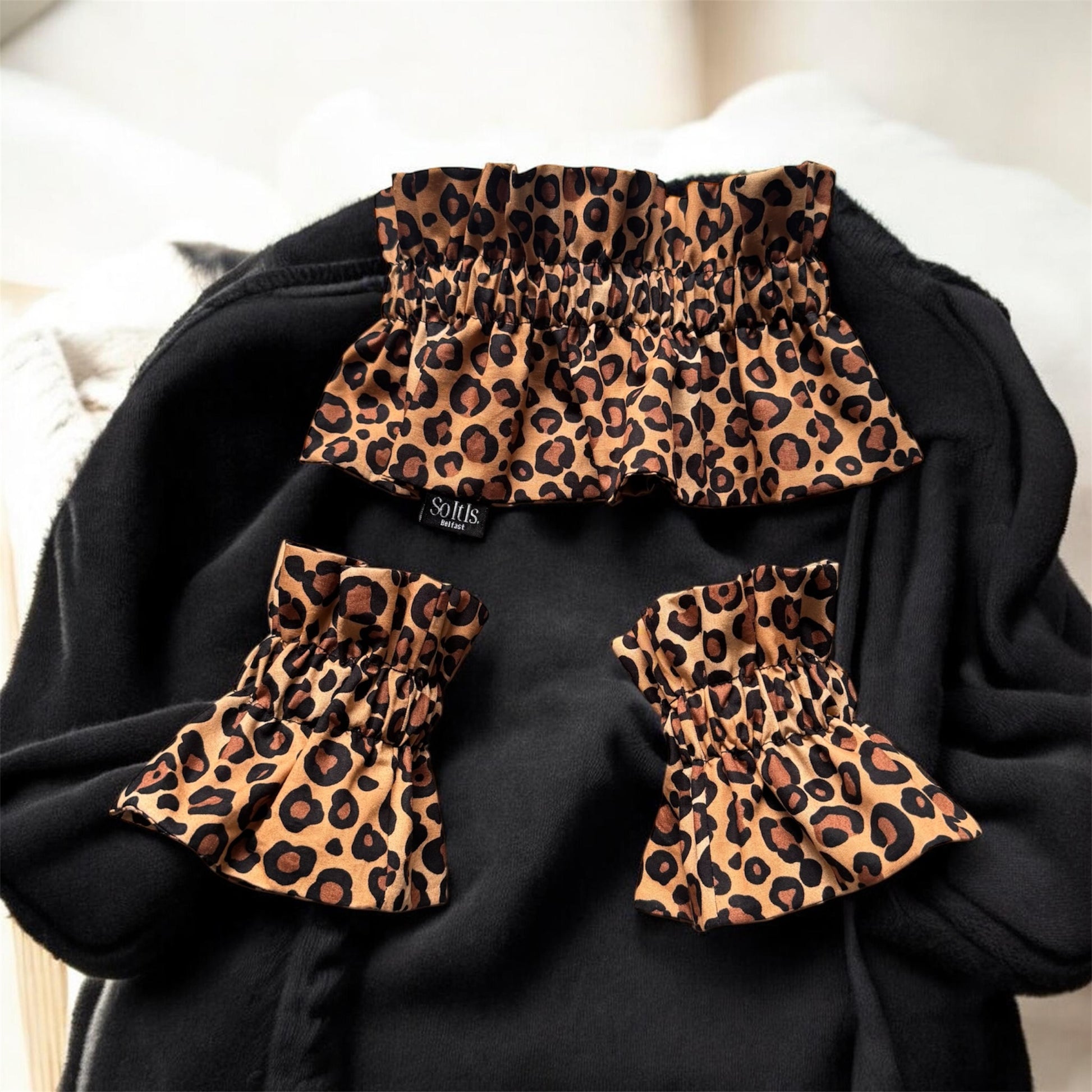 Leopard print detachable collar and matching cuffs displayed on black sweater by So It Is Belfast