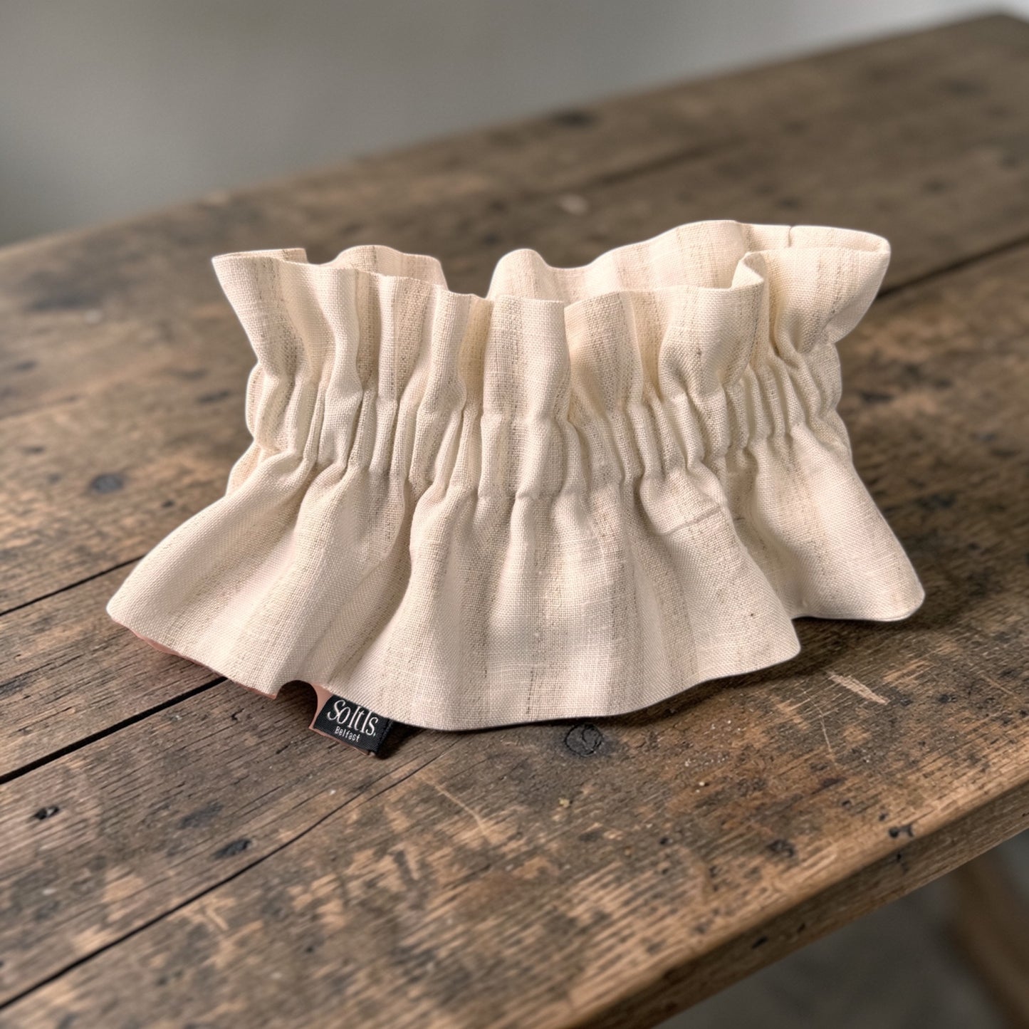 Cream detachable collar made from pure Irish linen with soft gathered detail, displayed on rustic wood
