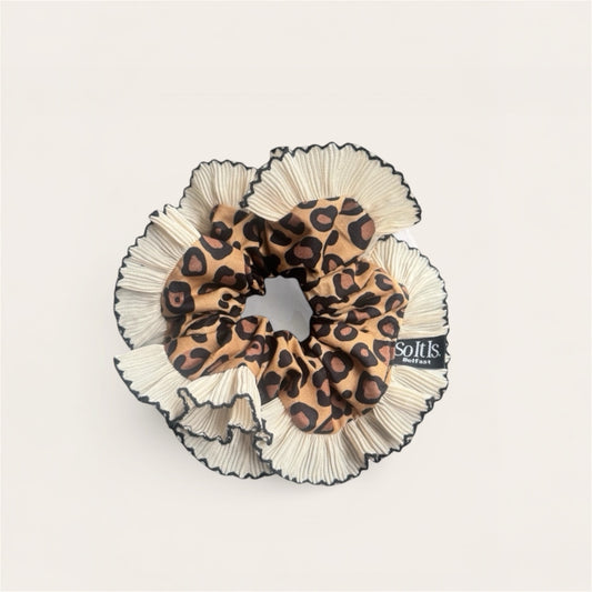 Leopard print scrunchie with cream & black ruffled edges on a light gray background